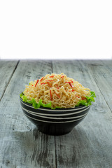 Instant noodle in the bowl on wooden background