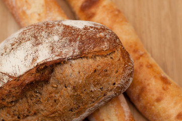 dark French bread with seeds sprinkled with flour