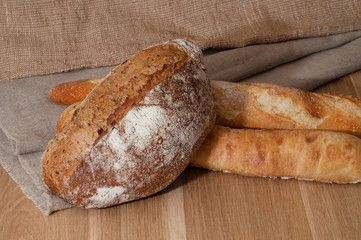 French bread and two baguettes on a background of cloth