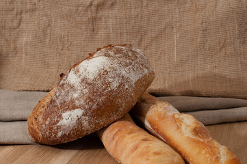 French bread and two baguettes on a background of cloth