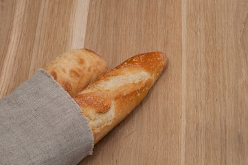 Two baguettes wrapped in a linen napkin