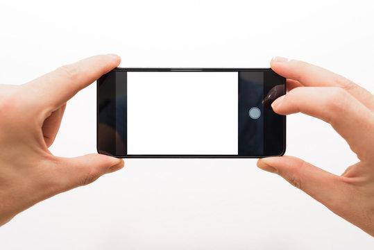 two male hands horizontally holding a smartphone ready to take a picture isolated on white