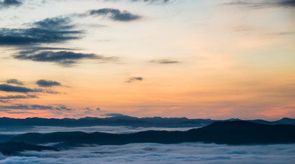 Beautiful Sea of mist in the morning with layer of mountain and sunrise