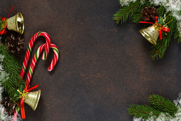 New Year card. Christmas tree with cones and candies on a brown background with space under the text.