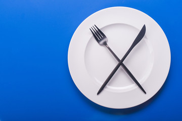 knife and fork on blue table