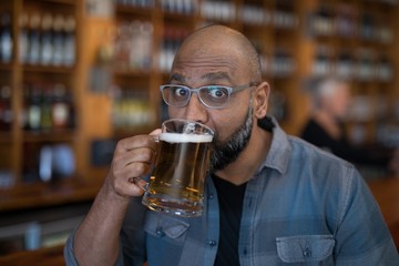 Man having glass of beer in restaurant