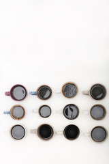 Obraz na płótnie Canvas Twelve mugs of coffee isolated on white background with copy space