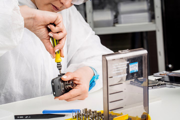Close up hands of a service worker repairing Car DVR Front camera recorder.