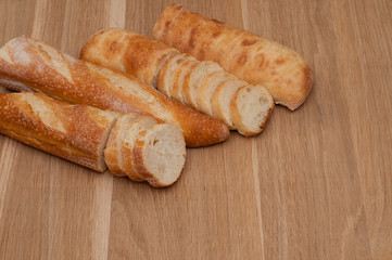 French loaf and ciabatta on a wooden board with space for text