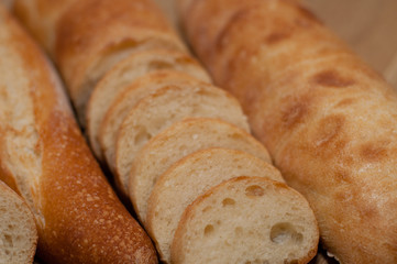 French loaf and ciabatta on a wooden board with space for text
