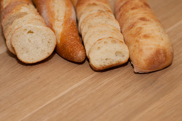 French loaf and ciabatta on a wooden board with space for text