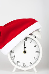 Vintage alarm clock in Santa Claus hat.