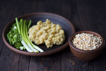 pea porridge, peas and onions in a clay pot on a wooden table