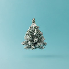 Christmas Tree on bright blue background. Minimal holiday concept.