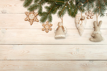 Greeting card with decor gingerbread cookies, fir tree branch on white wooden background. Overhead...