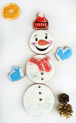 Merry Christmas and New Year homemade gingerbread cookie in the shape of snowman on light background