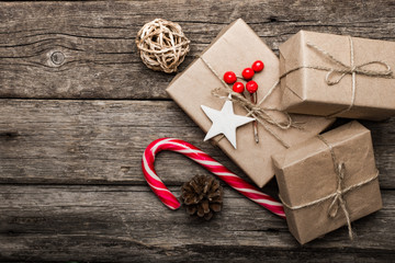 Christmas presents on dark wooden board.