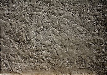 Old stucco wall texture of dark gray color