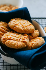 Homemade peanut butter cookies on a wire rack. Gray background. Rustic style.