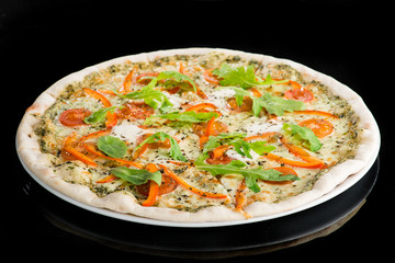 Traditional delicious Italian pizza with tomato, cheese, pepper and basil on dark background