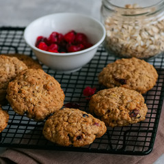 Homemade oatmeal cookies with dried fruits on a wire rack.