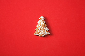 Gingerbread tree on a red background. The basis for the design of the poster or postcards. It is...