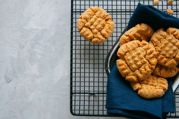 Homemade peanut butter cookies on a wire rack. Gray background. Rustic style.