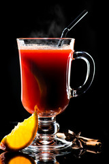 Hot non-alcoholic mulled wine with orange and cinnamon Isolated on black background