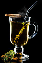 Hot Amaro cocktail with apple juice and cinnamon with steam