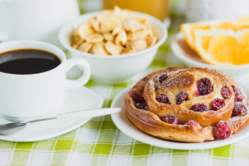 Cup of coffee, baking, muesli and orange