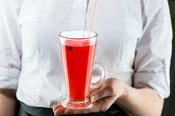 The unidentified waiter brings a hot cranberry tea cocktail with lemon and cinnamon