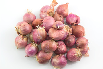 Pile of red onions with root on white background, Thai onions.