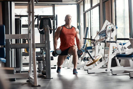 Strong man training with dumbbells