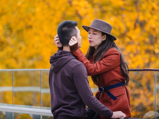 Fototapeta premium Chinese young man and woman standing together with emotional expression, lover concept.