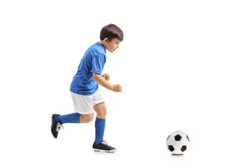Fototapeten Little footballer running towards a football © Ljupco Smokovski