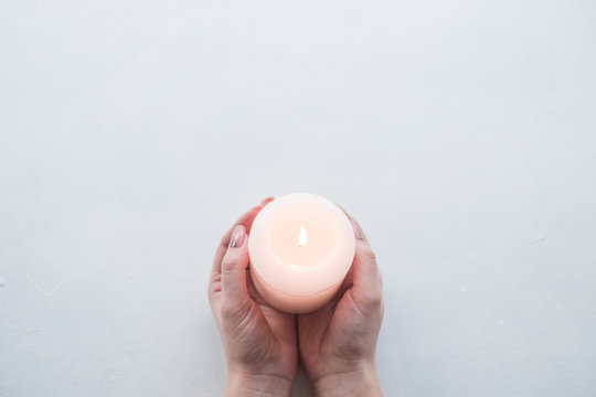 Hand Holding Candle As A Sign Of Remembrance Or Mourning On White Background. Grief And Loss Concept