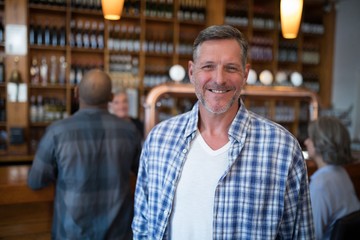 Happy man standing in bar