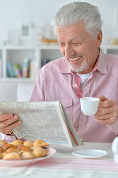 senior man reading newspaper