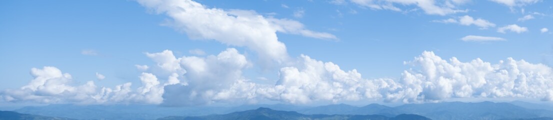 Fototapeta premium Panorama shot, Beautiful white clouds on blue sky. View from high mountain at Doi Pha Tung, Chiangrai, Thailand, Lao.
