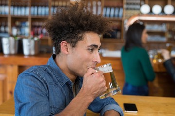 Man drinking glass of beer