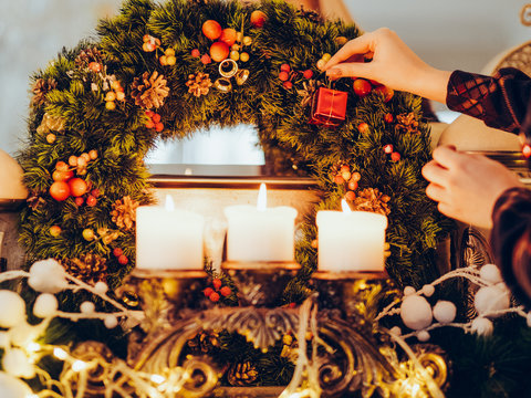 Festive Decoration Preparing Home Coziness Concept. Christmas Wreath And Candles Light. Magic Of Winter Holidays.