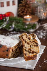 Obraz na płótnie Canvas Sliced Christmas Stollen. Traditional german christmas cake with dried fruits and icing sugar