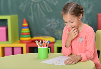 Cute girl drawing with pencils