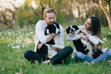 Beautiful couple walking dogs and bonding in nature