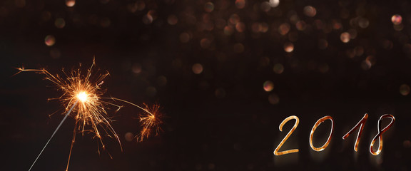 New year background 2018 with a sparkler