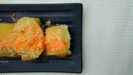 Singkong Keju, Indonesia Traditional Snack Food, made from Steamed Cassava and grated Cheese and Chili Powder for Topping