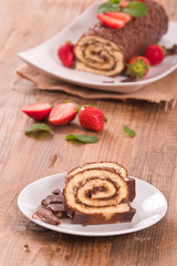 Chocolate roll with hazelnuts and strawberries. 
