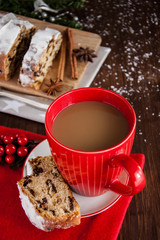 Sliced Christmas Stollen. Traditional german christmas cake with dried fruits and icing сигар with red coffee mug 