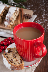 Sliced Christmas Stollen. Traditional german christmas cake with dried fruits and icing сигар with red coffee mug 