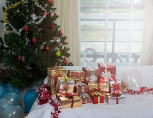 Many Christmas presents gift boxes on a table with Christmas tree